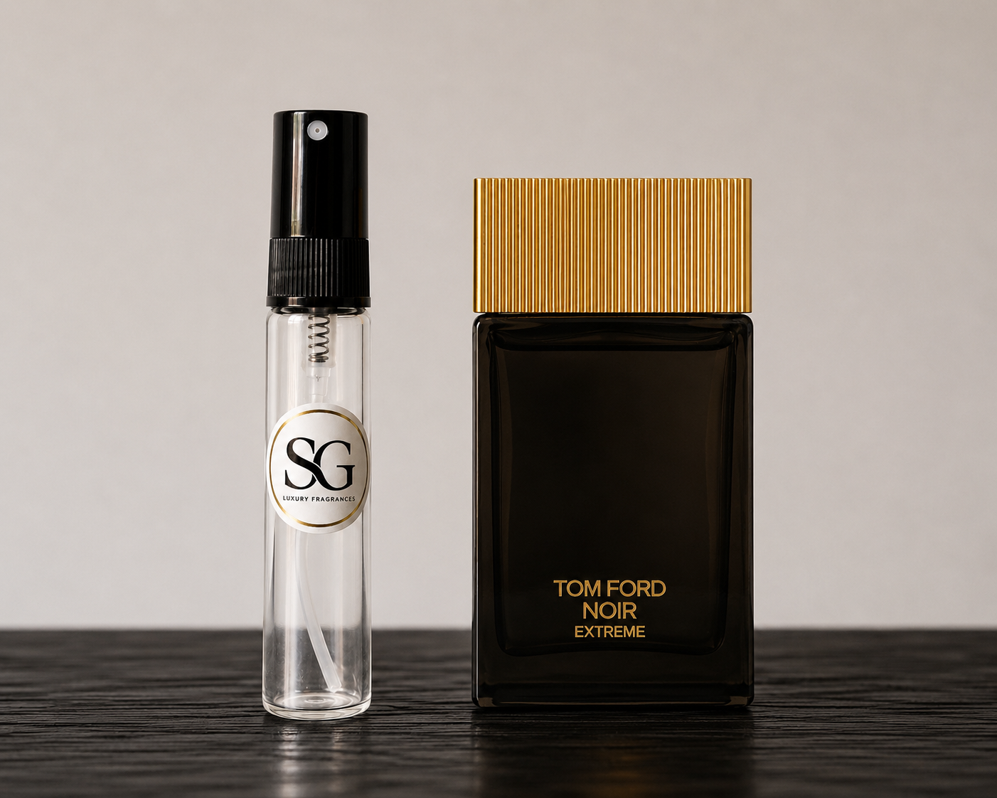 Tom Ford Noir Extreme perfume bottle and a smaller clear bottle with black cap on a dark surface.