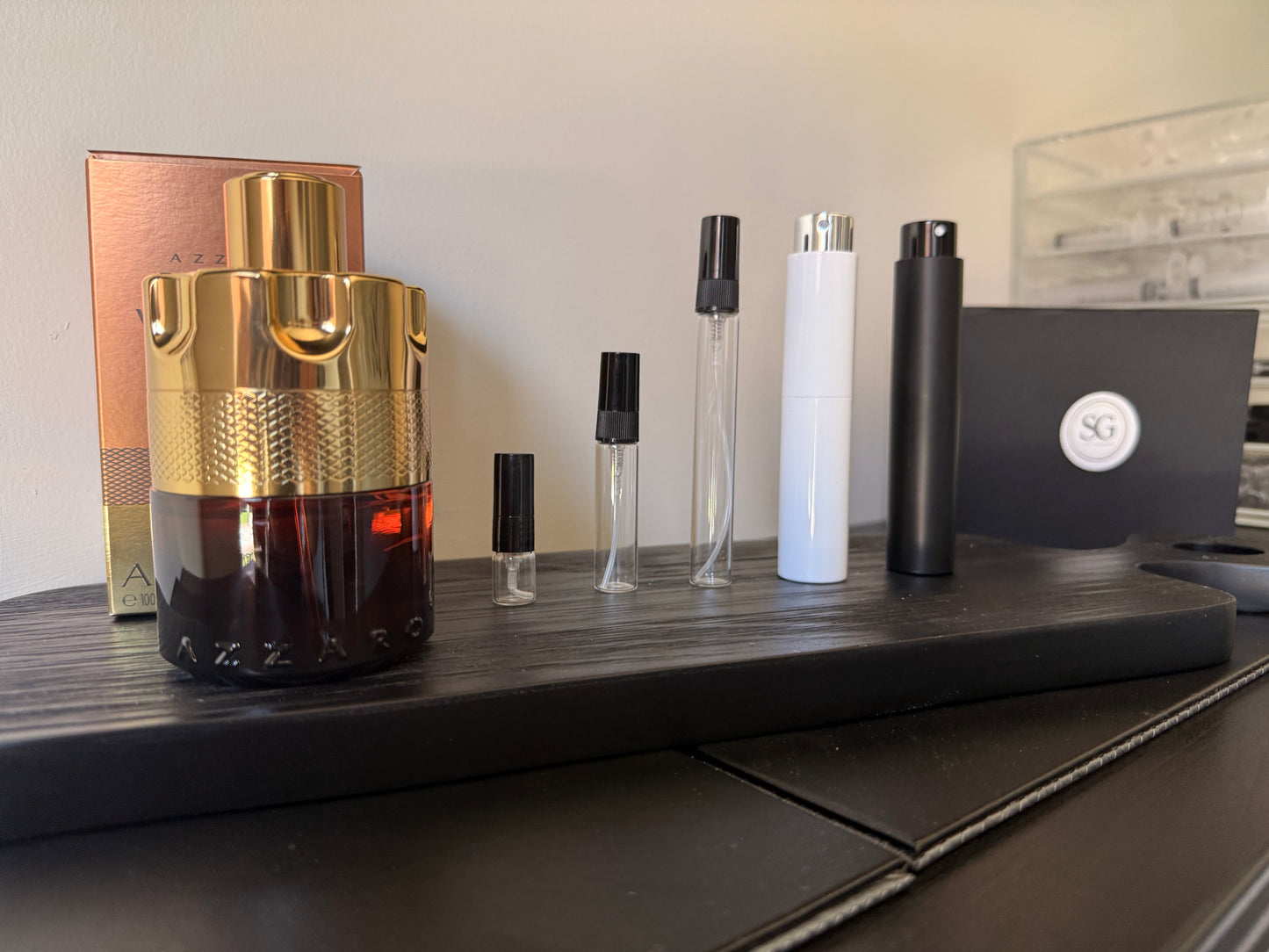 Collection of perfume bottles and packaging on a wooden surface