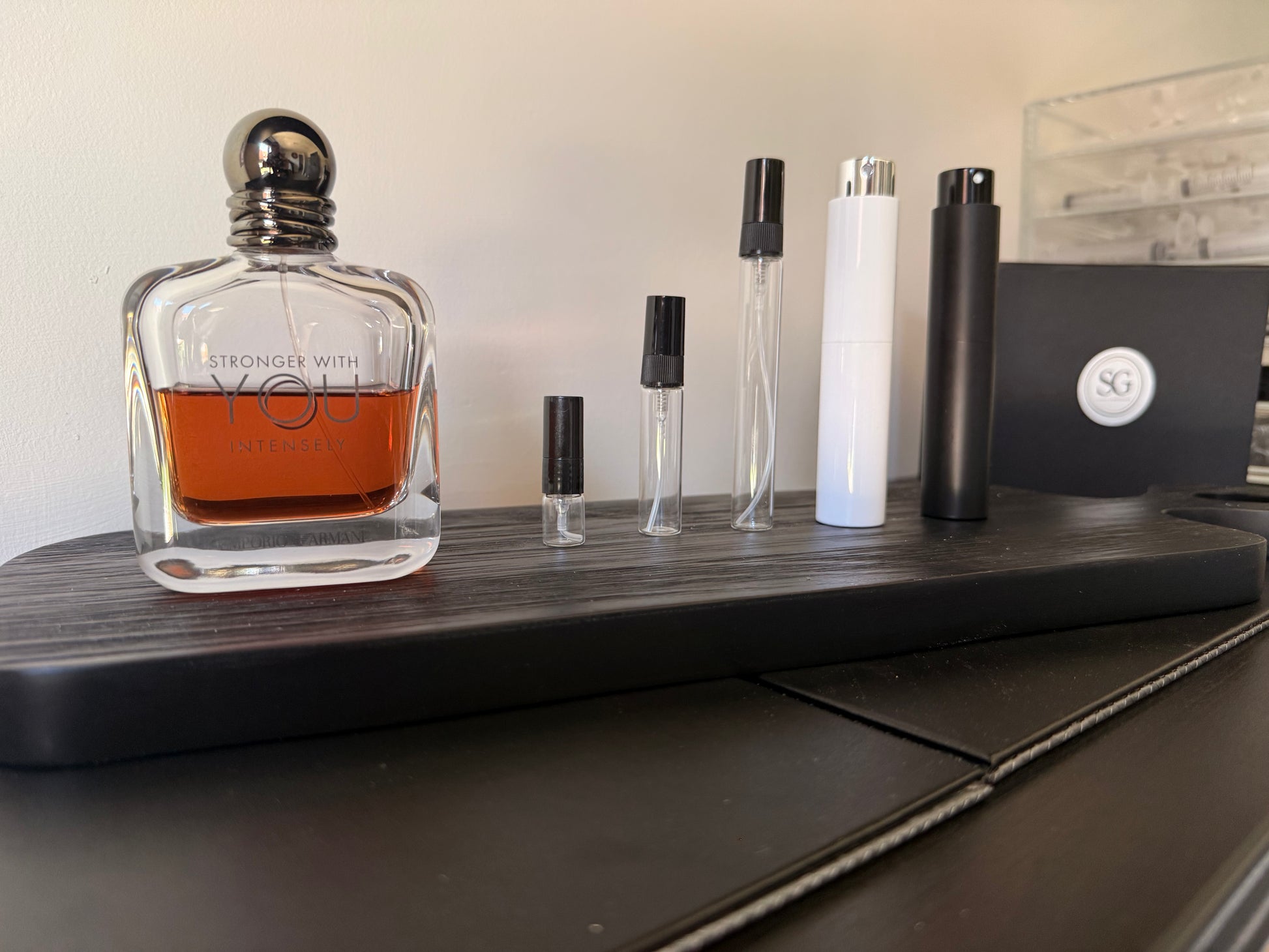 Perfume bottle with orange liquid on a wooden surface