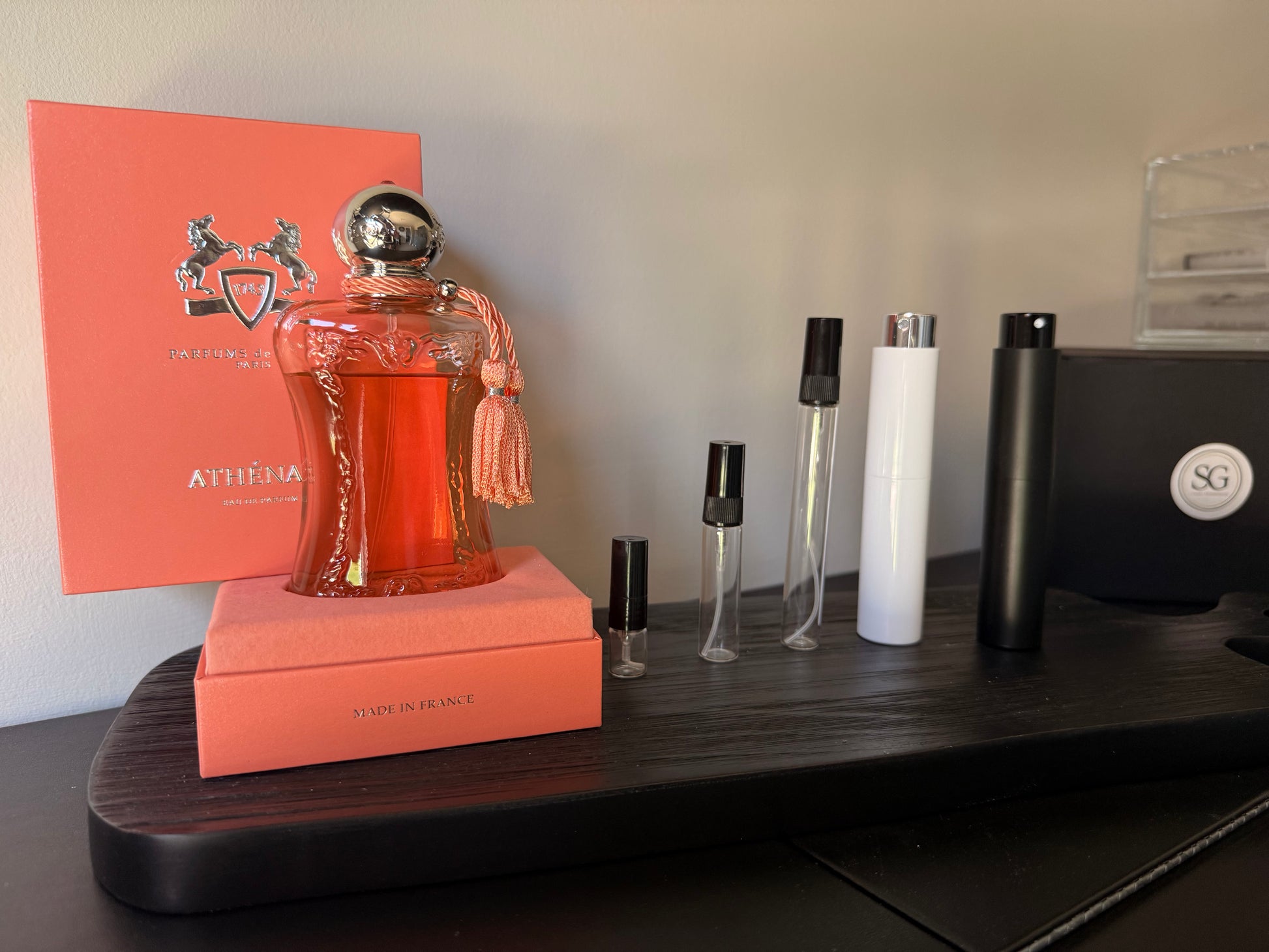 Perfume bottle with orange packaging on a wooden surface