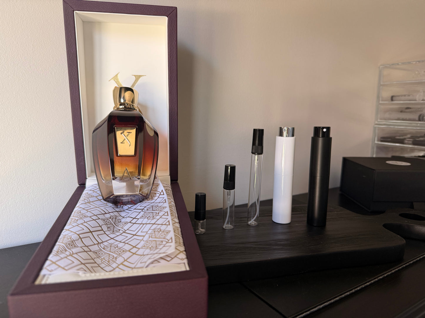 Perfume bottle with decorative box on a wooden surface