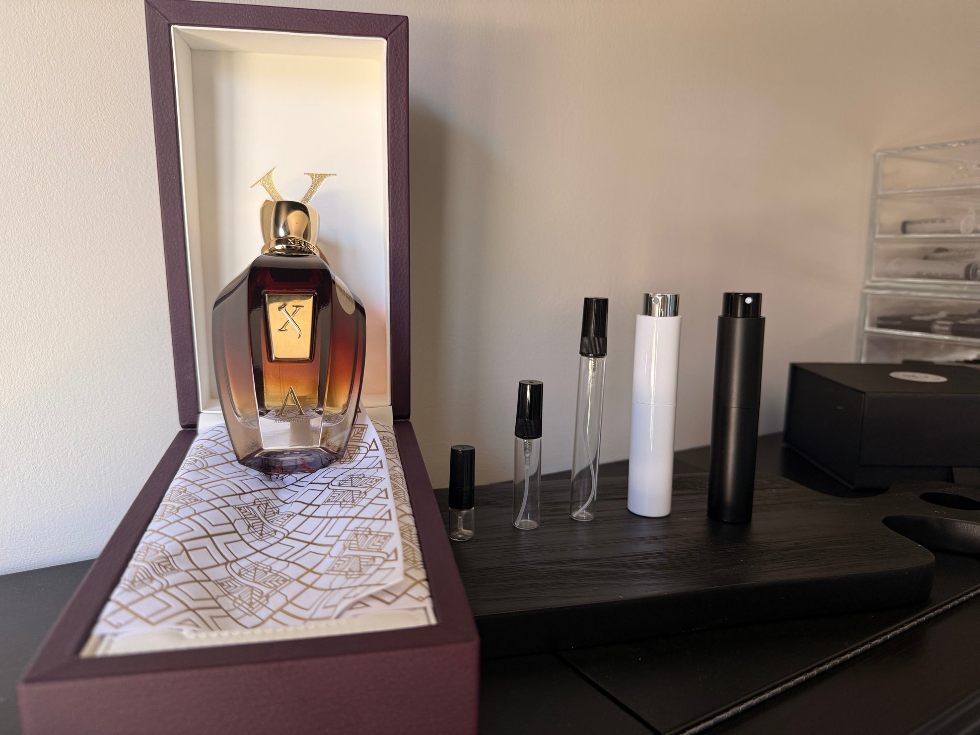 Perfume bottle with decorative box on a wooden surface