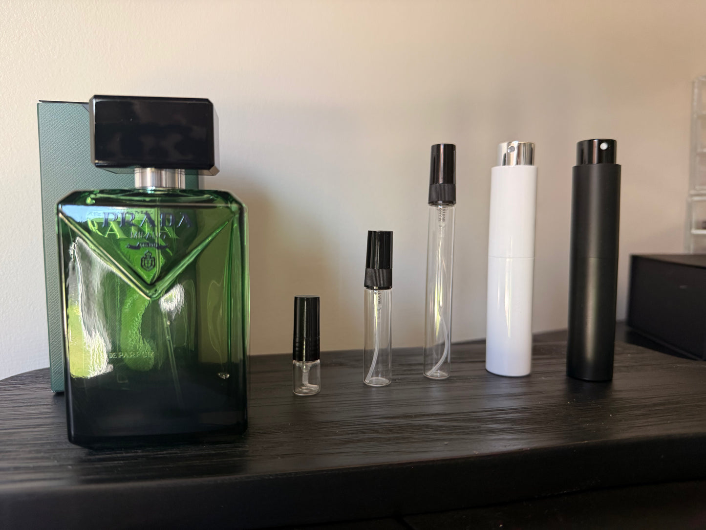 Collection of perfume bottles on a wooden surface with a neutral background
