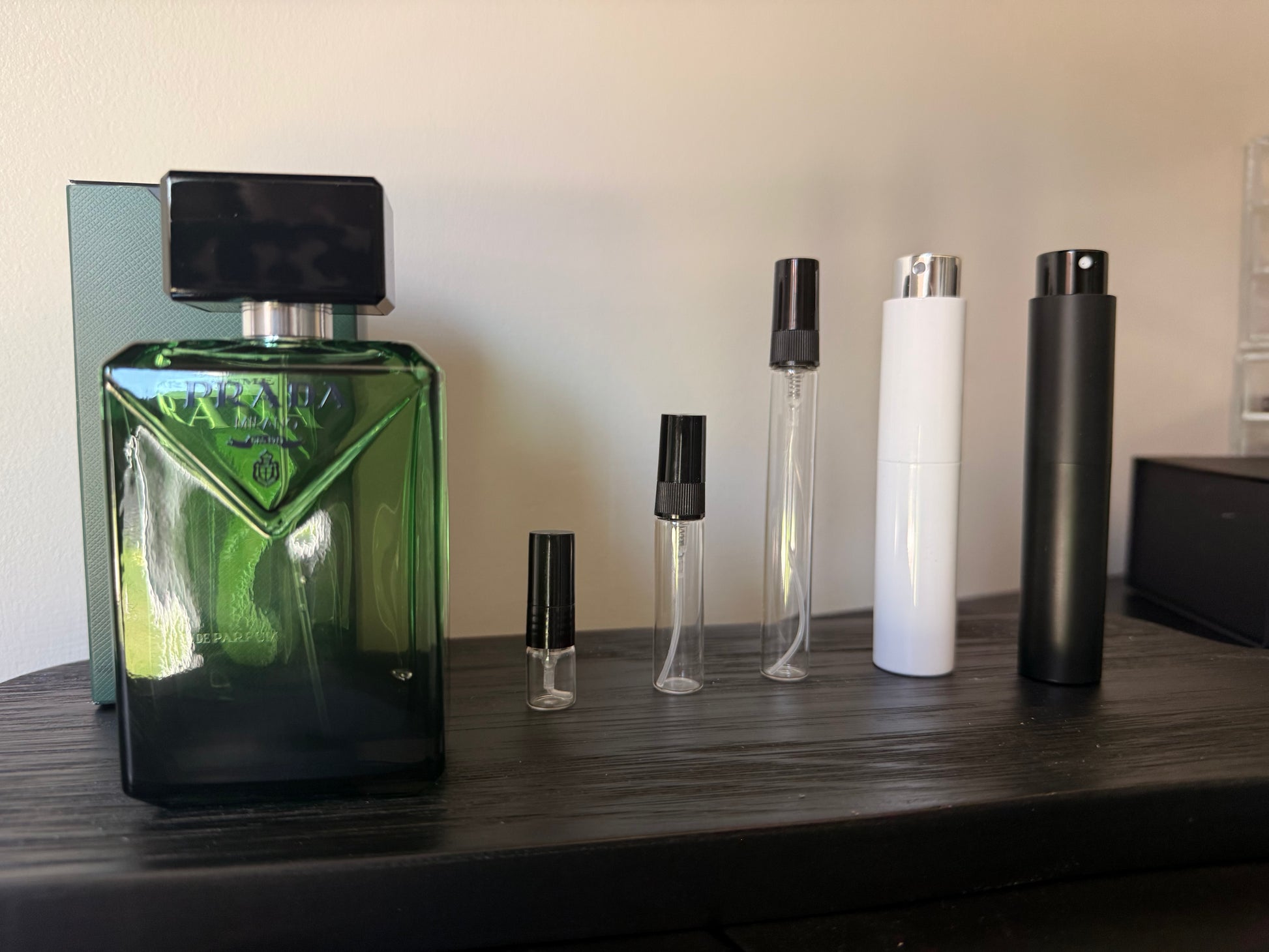 Collection of perfume bottles on a wooden surface with a neutral background