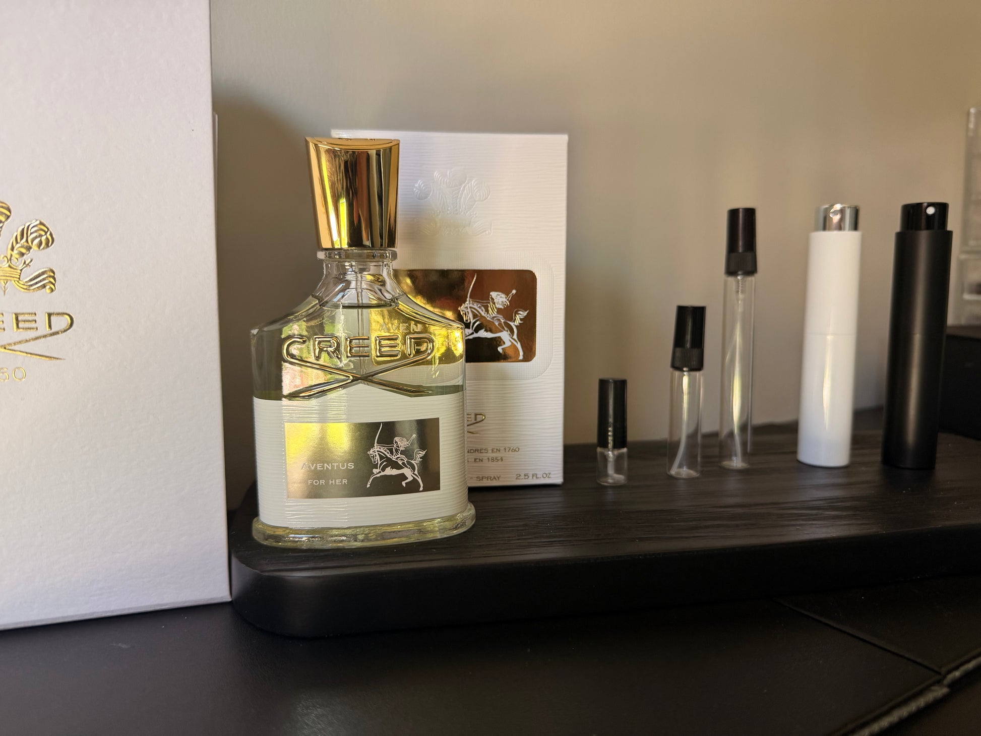 Creed perfume bottle on a shelf with other products in the background
