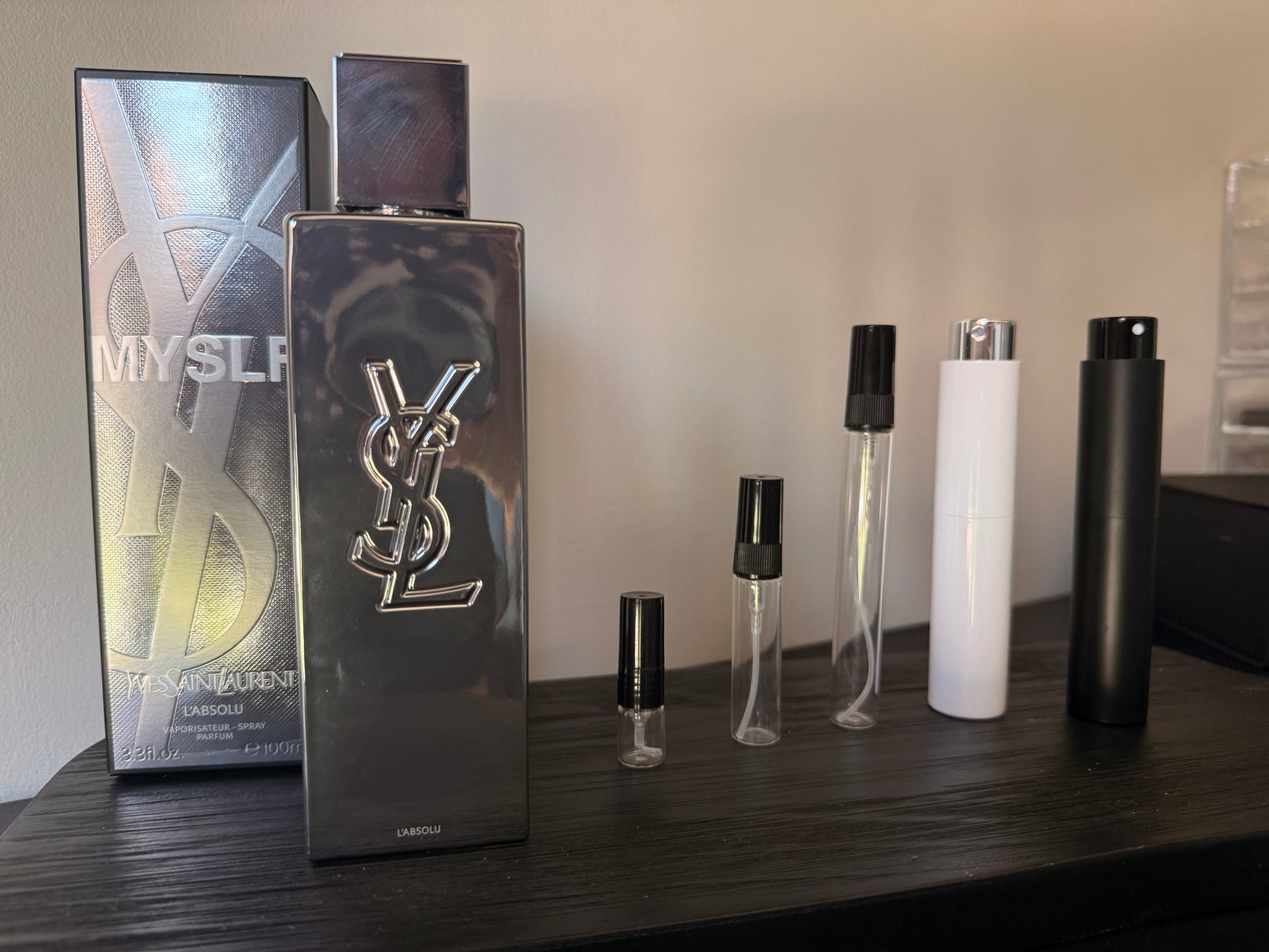 YSL perfume bottle and packaging on a wooden surface