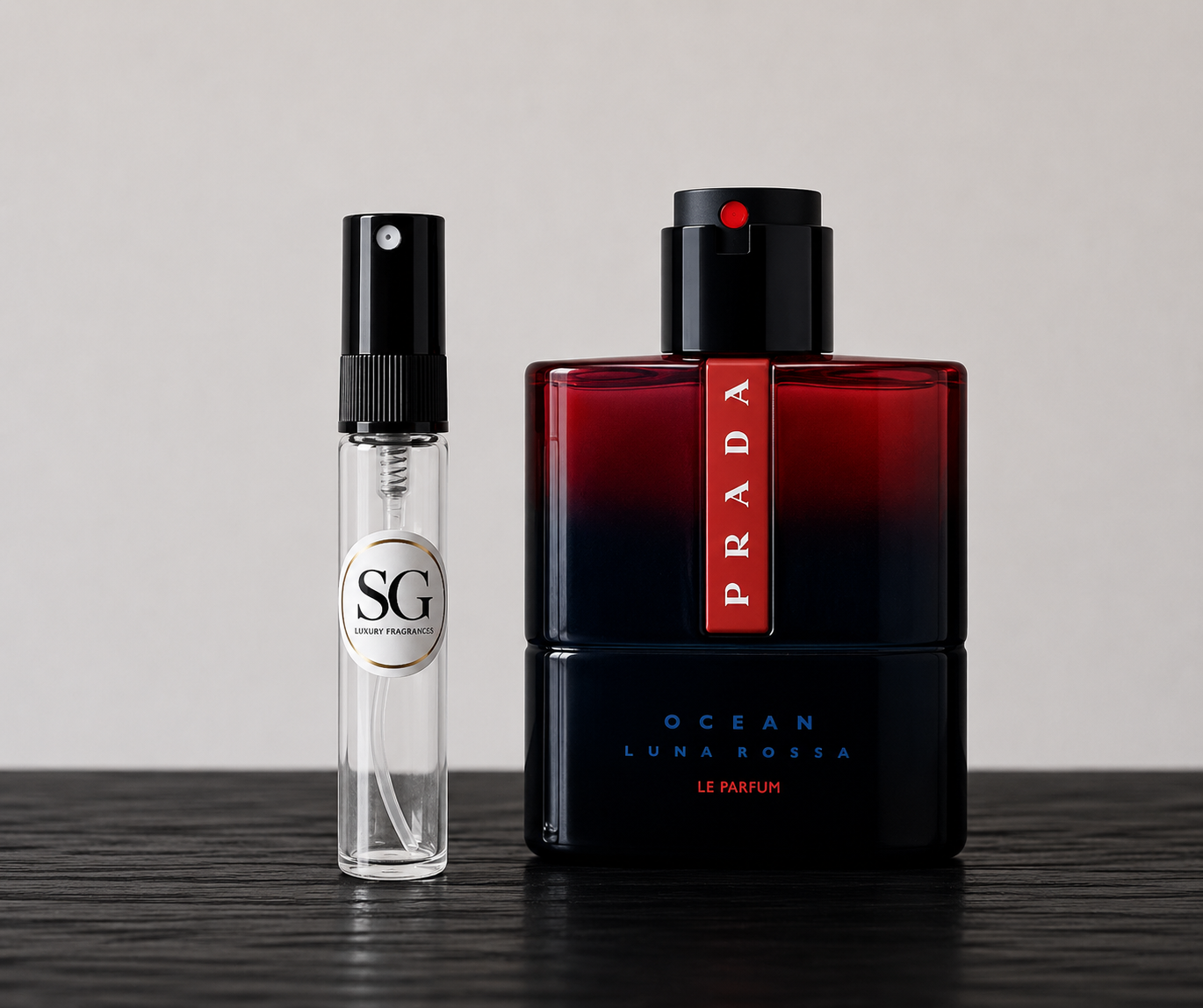 Two perfume bottles, one clear with black cap and one black with red label, on a wooden surface.
