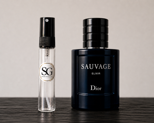 Two perfume bottles, one small and clear, the other large and black with 'Sauvage' branding, on a wooden surface.