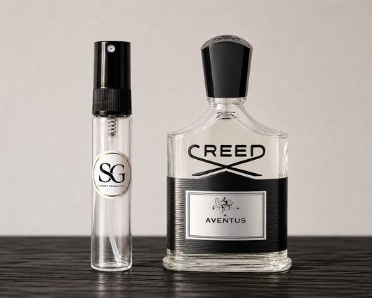 Two Creed perfume bottles on a wooden surface with a neutral background