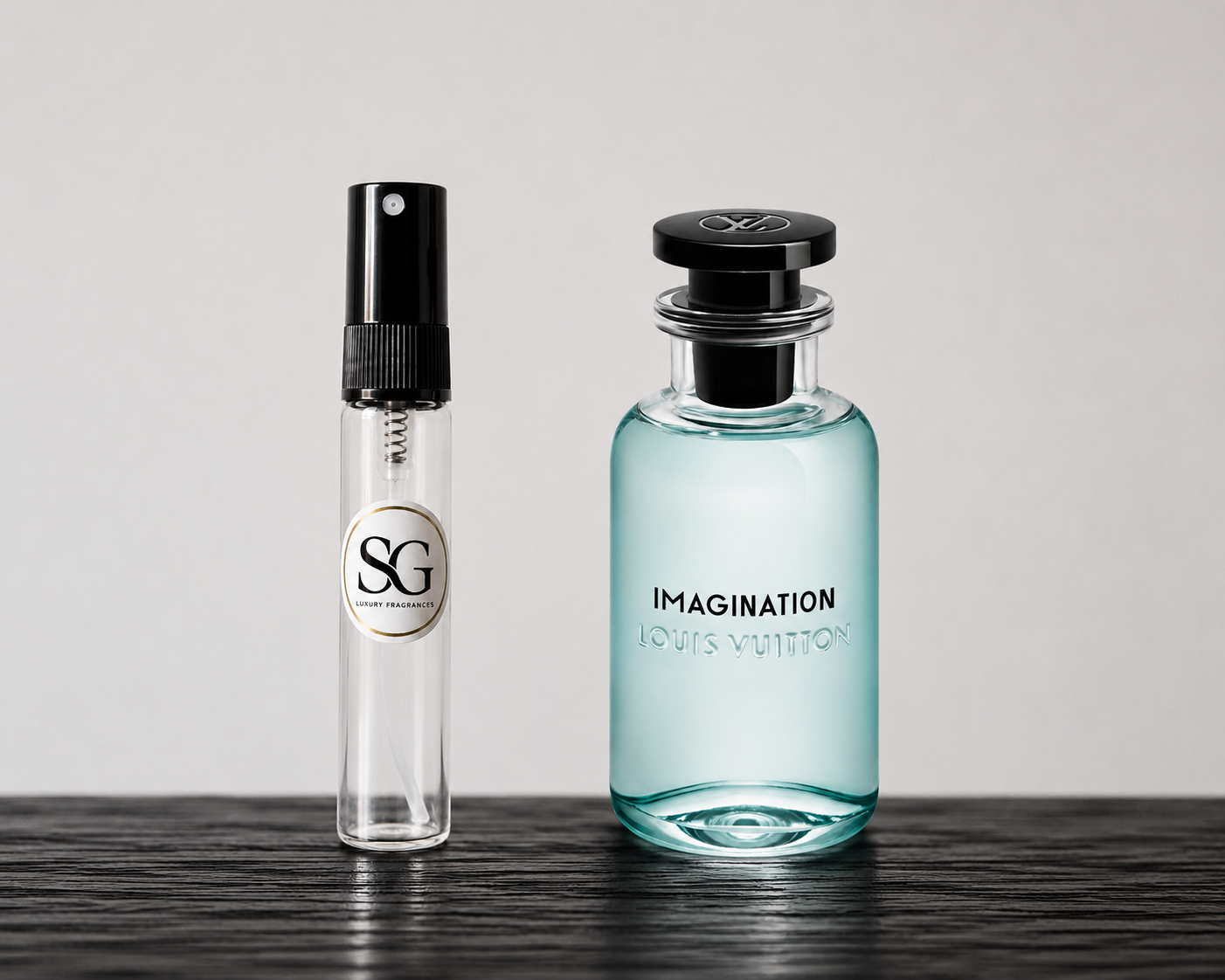 Two perfume bottles, one small and one large, on a wooden surface with a neutral background.