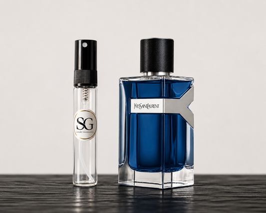 Two perfume bottles, one blue and one clear with black cap, on a dark surface.