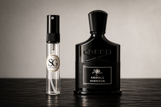 Two Creed perfume bottles on a wooden surface with a neutral background