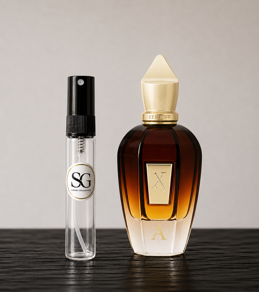 Two perfume bottles, one large and one small, on a wooden surface with a neutral background.