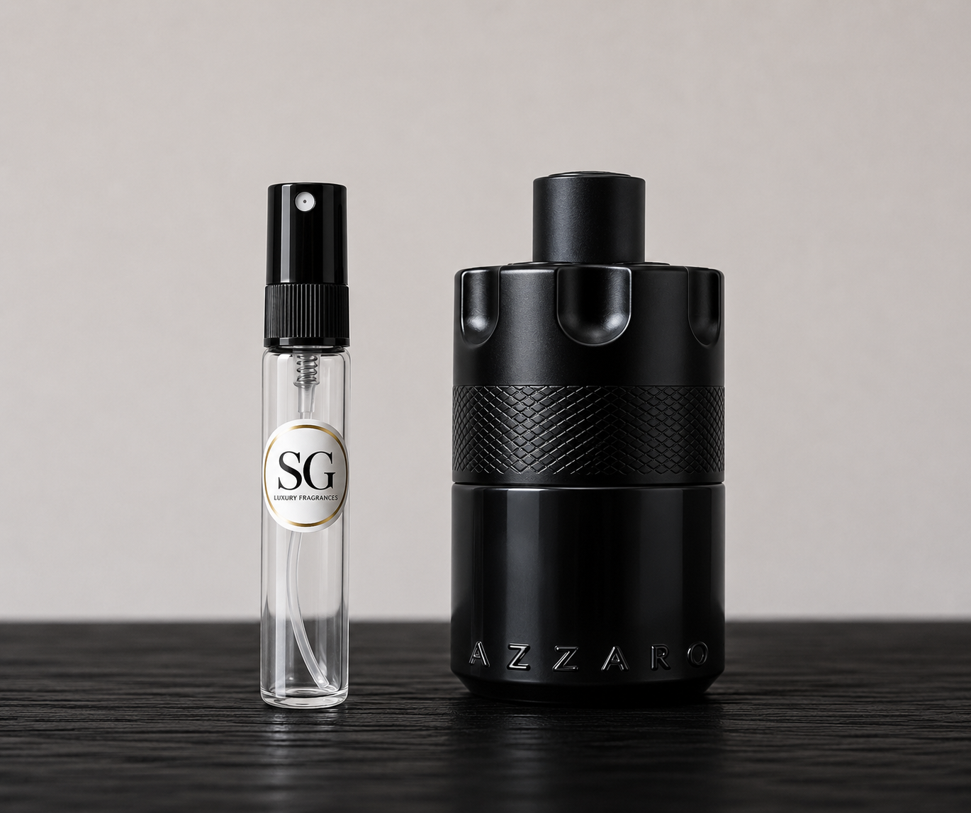 Two black perfume bottles, one large and one small, on a wooden surface with a neutral background.