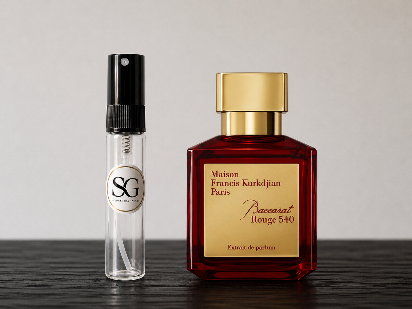 Two perfume bottles, one red and gold, the other clear with black cap, on a wooden surface.